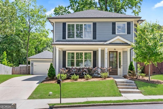 view of front of property with a garage, a front yard, and covered porch