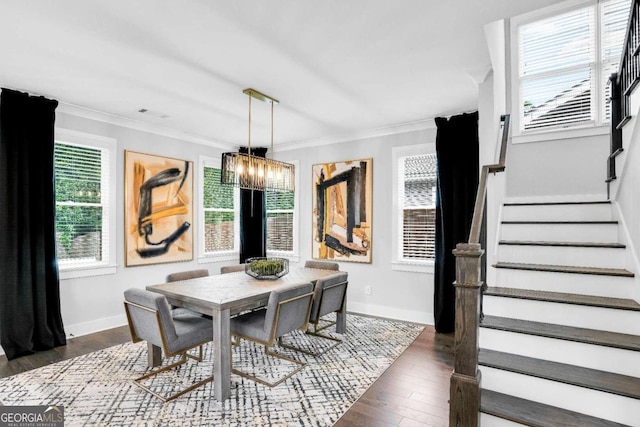 dining area featuring an inviting chandelier, dark hardwood / wood-style floors, and ornamental molding