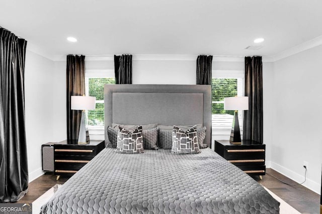 bedroom with crown molding and dark hardwood / wood-style flooring