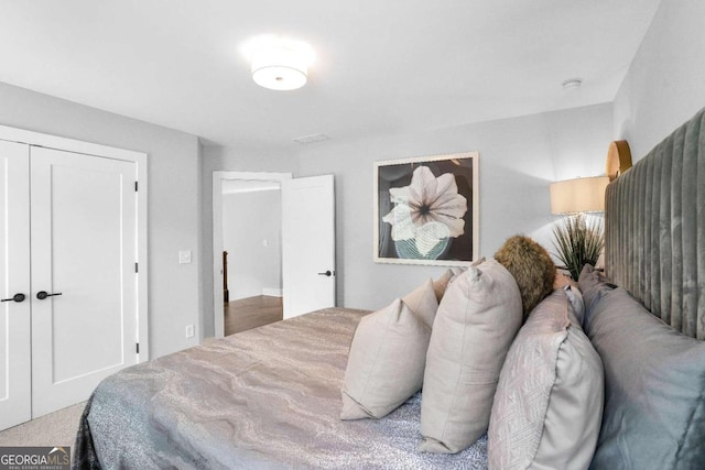 bedroom with carpet and a closet