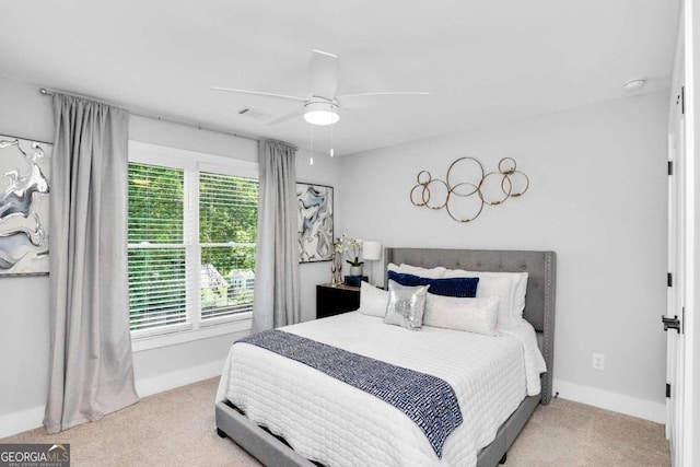 bedroom featuring light carpet and ceiling fan