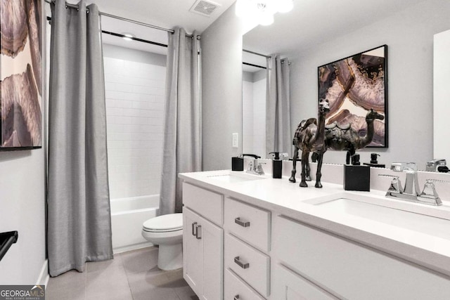 full bathroom featuring toilet, tile patterned floors, double sink vanity, and shower / tub combo