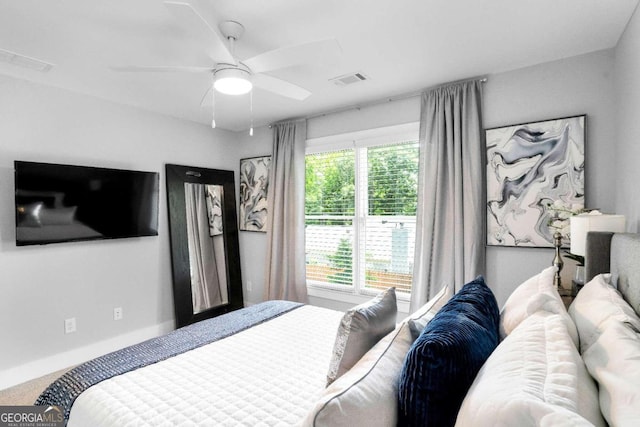 bedroom with multiple windows, carpet, and ceiling fan