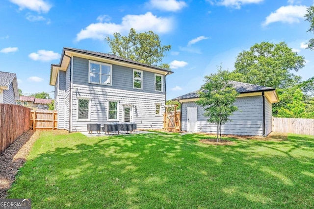 back of property with a patio area and a lawn