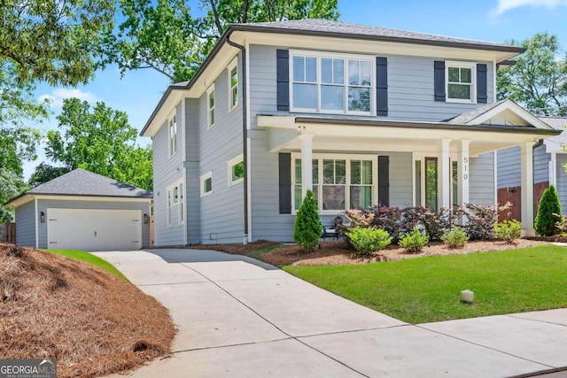 view of front of house featuring a garage, a porch, an outdoor structure, and a front yard