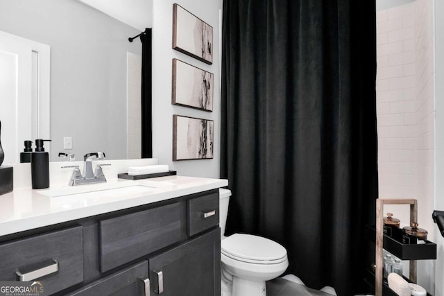 bathroom with vanity, tile patterned flooring, and toilet