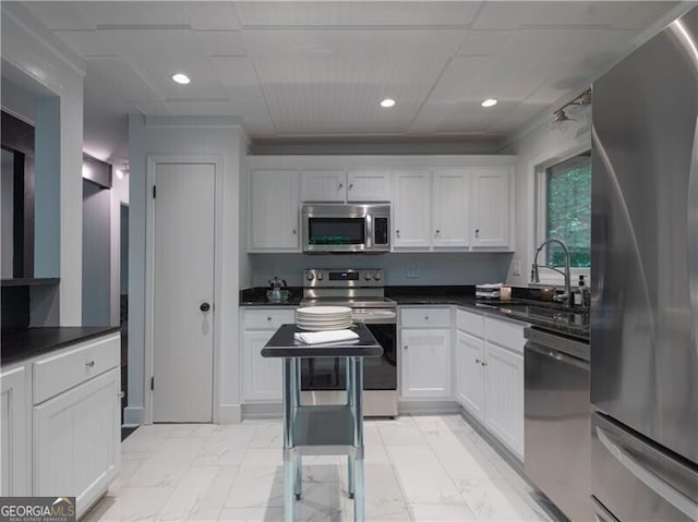 kitchen featuring sink, stainless steel appliances, and white cabinetry