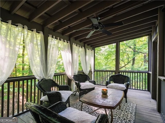 sunroom / solarium featuring ceiling fan