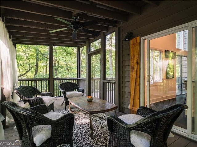 sunroom / solarium with ceiling fan and beamed ceiling