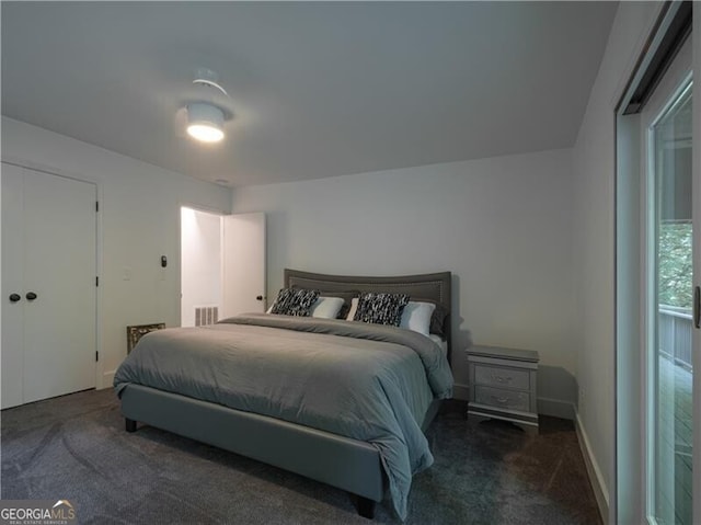 bedroom with dark colored carpet