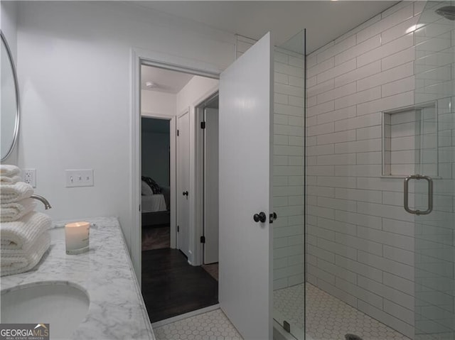 bathroom with tile patterned flooring, vanity, and walk in shower