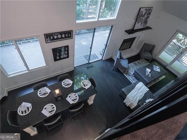 living room with a high ceiling and dark hardwood / wood-style floors