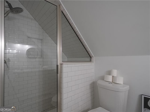 bathroom with vaulted ceiling, an enclosed shower, and toilet