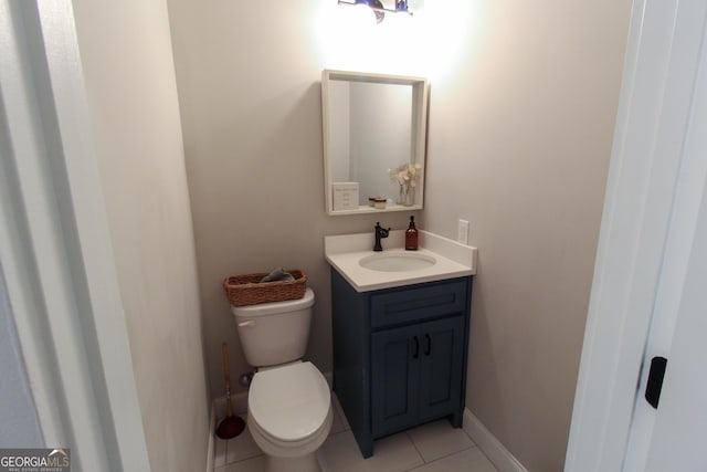 bathroom with baseboards, vanity, toilet, and tile patterned floors