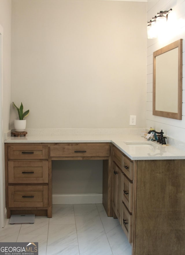 full bathroom featuring marble finish floor and vanity