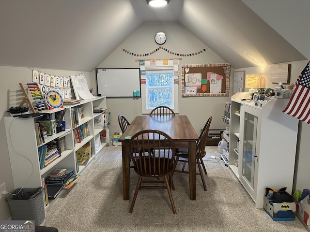 dining space featuring vaulted ceiling and carpet flooring