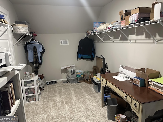 spacious closet featuring vaulted ceiling, carpet, and visible vents