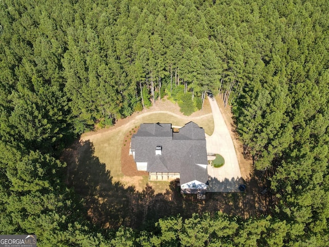 bird's eye view with a wooded view