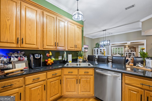 kitchen with pendant lighting, crown molding, visible vents, stainless steel dishwasher, and a sink