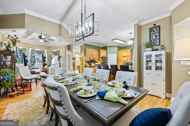 dining space with a ceiling fan, crown molding, and light wood-style flooring