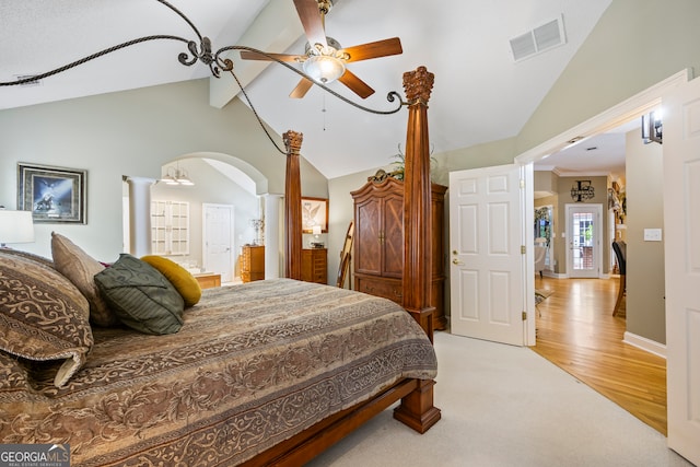 bedroom featuring visible vents, arched walkways, a ceiling fan, lofted ceiling with beams, and light wood-type flooring