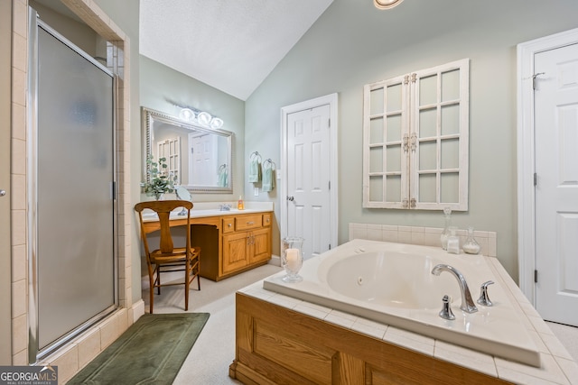 bathroom with a shower stall, a tub with jets, vaulted ceiling, and vanity