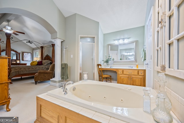 full bath featuring lofted ceiling, ceiling fan, ensuite bathroom, a stall shower, and decorative columns