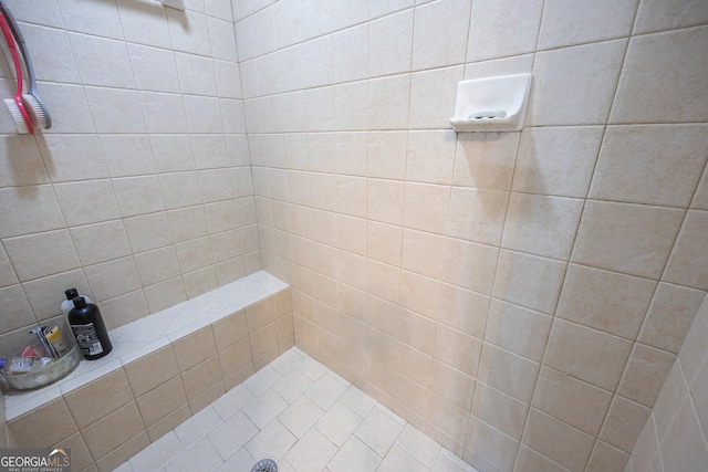 bathroom with a tile shower