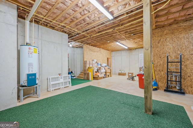 unfinished basement with water heater and stairway