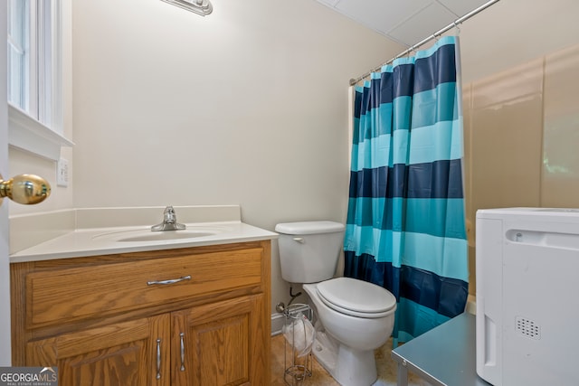 bathroom with curtained shower, vanity, and toilet