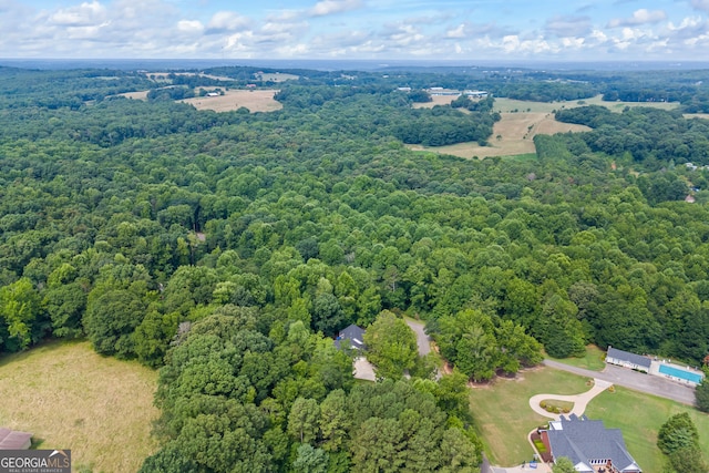 birds eye view of property with a wooded view