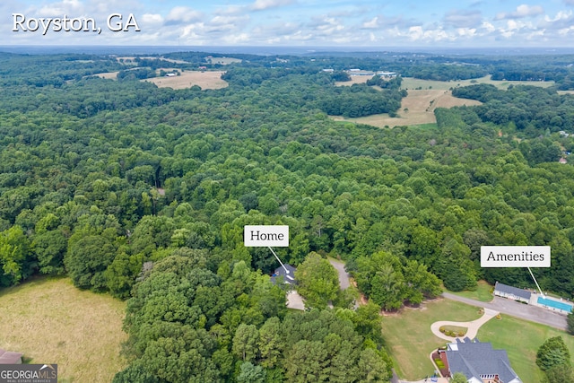 birds eye view of property with a wooded view