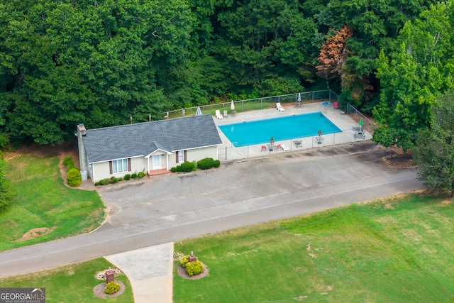 pool with a lawn and fence