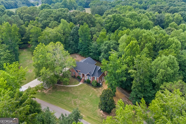 drone / aerial view featuring a view of trees