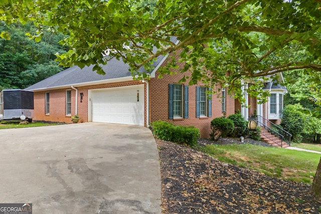 view of front of property with a garage, brick siding, driveway, and roof with shingles