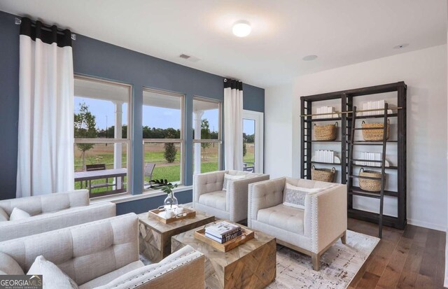 sitting room with hardwood / wood-style flooring