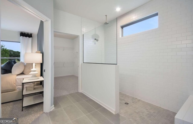 bathroom featuring a tile shower and tile patterned floors