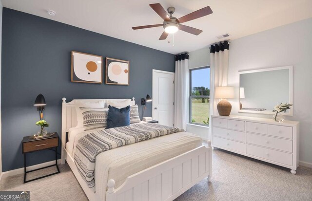 bedroom featuring light carpet and ceiling fan