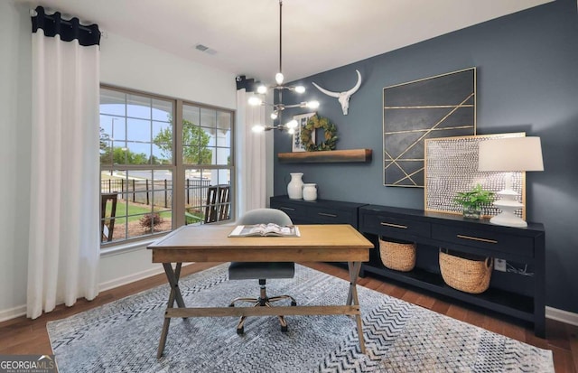 home office featuring dark hardwood / wood-style flooring and a chandelier