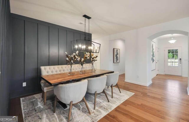 dining space featuring a chandelier and light hardwood / wood-style floors