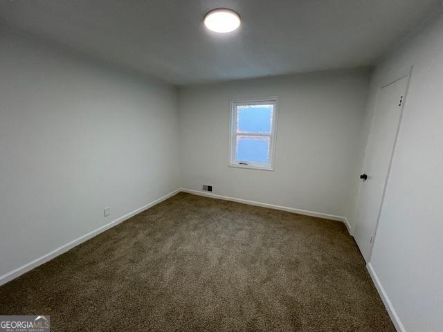 empty room with dark carpet