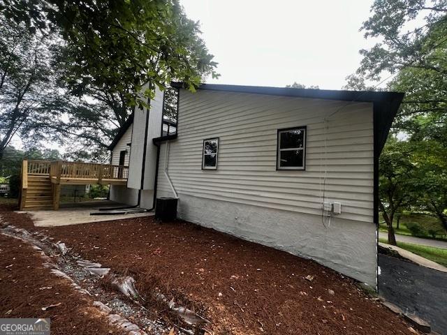 view of home's exterior featuring a wooden deck