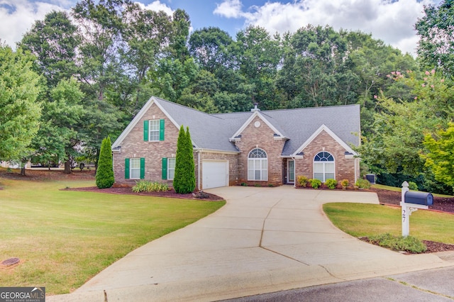 view of front of house featuring a garage and a front lawn