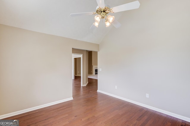 unfurnished room featuring lofted ceiling, hardwood / wood-style flooring, and ceiling fan