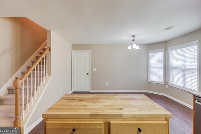 kitchen featuring dishwasher, hanging light fixtures, hardwood / wood-style floors, light brown cabinetry, and a chandelier