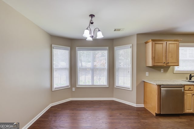 kitchen featuring dark wood-type flooring, stainless steel dishwasher, plenty of natural light, and hanging light fixtures