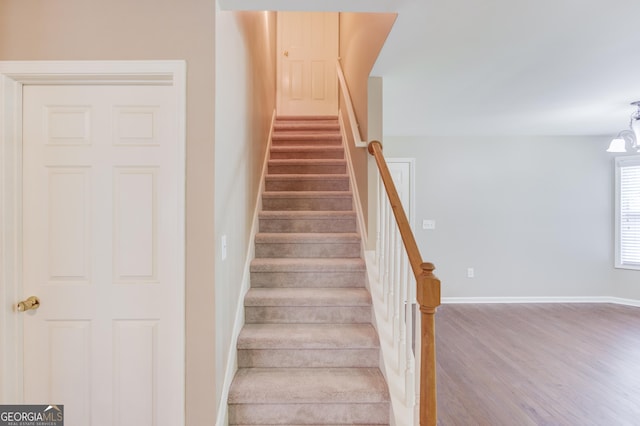 stairs featuring hardwood / wood-style flooring