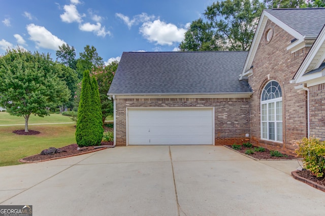 exterior space with a garage and a yard