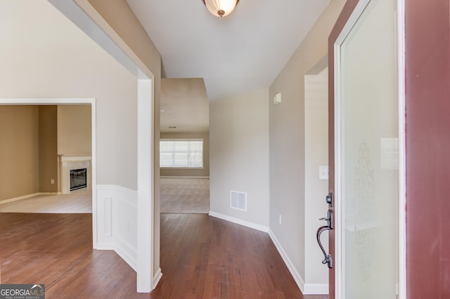 entryway featuring wood-type flooring and a premium fireplace