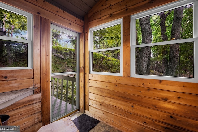 sunroom / solarium featuring wooden ceiling and vaulted ceiling